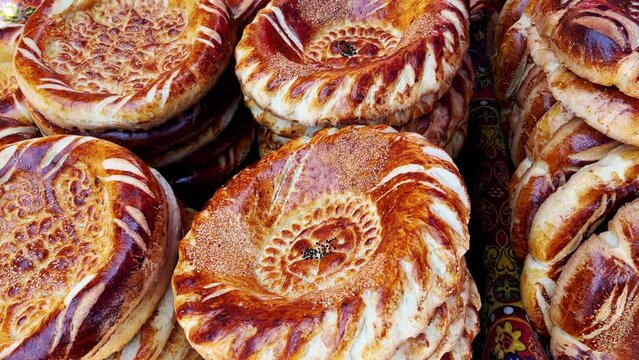 Tortillas on the market in Samarkand, Uzbekistan - June 29, 2023: Goods and traders at the Oriental Bazaar in Uzbekistan. Siab Bazaar is the largest and oldest bazaar in Samarkand. 4K