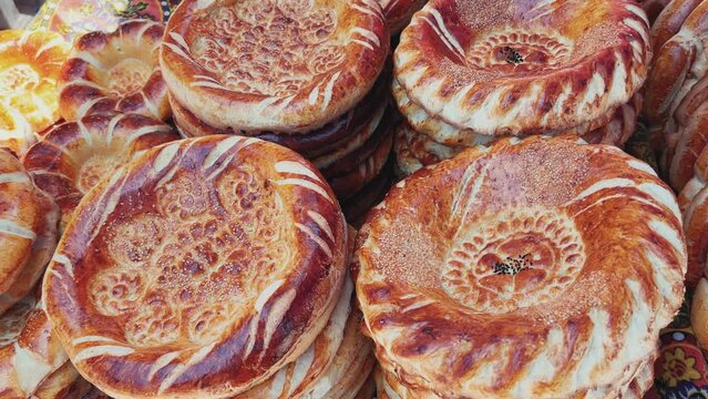 Tortillas on the market in Samarkand, Uzbekistan - June 29, 2023: Goods and traders at the Oriental Bazaar in Uzbekistan. Siab Bazaar is the largest and oldest bazaar in Samarkand. 4K