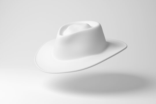 White cattleman hat floating in mid air on white background in monochrome and minimalism. Illustration of the concept of men fashion and western cowboy