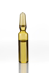 Pharmaceutical ampoule with medication on white table against. Close-up
