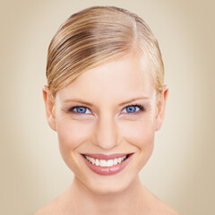Portrait, smile for beauty and woman with blue eyes in studio on beige background for natural...