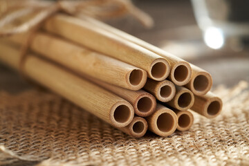 A bundle of bamboo straws on a table, close up