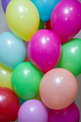 a bunch of bright multi-colored helium balloons