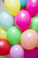 a bunch of bright multi-colored helium balloons