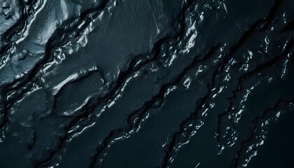 Fototapeta premium Dark obsidian lavic rock surface texture, black, smooth, shiny