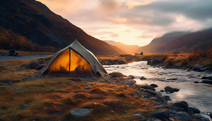 tent against the backdrop of dawn in the mountains near a river with a blurred background - obrazy, fototapety, plakaty