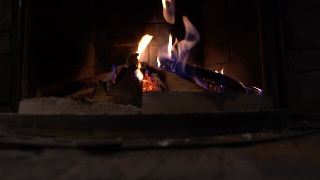 Idyllic view of cozy fireplace inside of restaurant in the Swiss Alps in the evening. Movie shot February 12th, Fronalpstock, Stoos, Canton Schwyz, Switzerland.