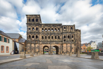 Trier, Germany. View of Porta Nigra - Grand Roman city gate dating from 180 AD with towers made from heavy stone slabs - obrazy, fototapety, plakaty