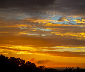 Beautiful idyllic sky at dawn with strong yellow and orange colors