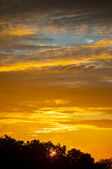 Fototapeta na wymiar Beautiful idyllic sky at dawn with strong yellow and orange colors
