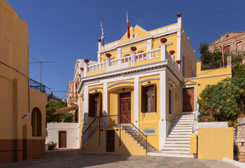 Multi-colored facades of houses in the Greek village Symi on a sunny day