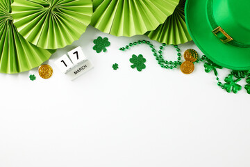 Clover charm and golden dreams: St. Patrick's Day in full swing. Top view shot of green paper fans,...