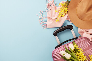 Springtime soiree: a stylish expedition. Top view photo of suitcase, modern hat, cozy scarf,...