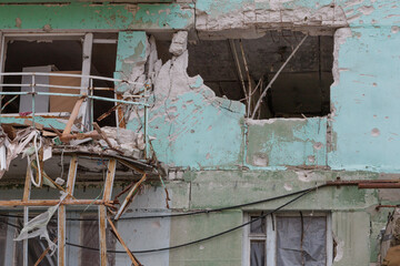 Closeup view of ruined facade of house.