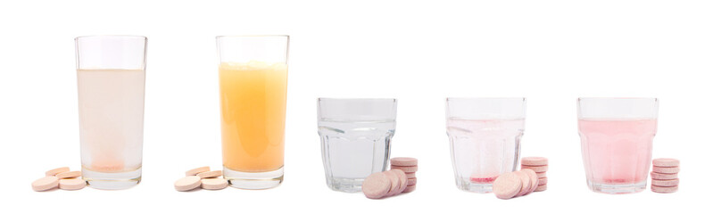 Vitamin C effervescent tablets with orange flavor drops and dissolves in a glass of water isolated on a white background. The concept of health. Medicine concept.