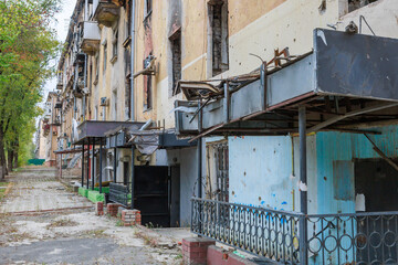 Fototapeta premium Closeup view of ruined facade of house in Mariupol.