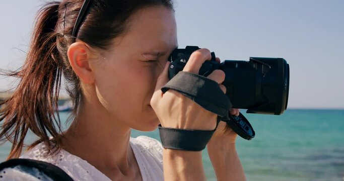 Female traveler take photo on camera of sightseeing in vacation. Cinematic and inspiring travel blogger live motivational adventure