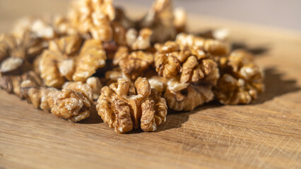 Peeled walnut kernels close-up on wooden background, Selective focus, tinted image.