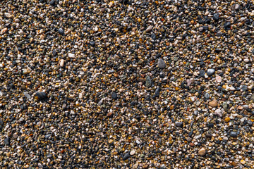 Close up of a Sea Shore Beach, Pebbles, Sand and Rocks Texture Abstract Background