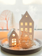 White ceramic house decoration with candle