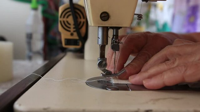 A close up shot from an old sewing machine working on a piece of cloth in southeast brazil