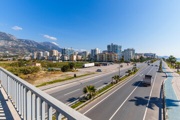 View of a Main Highway with Cars moving both ways in a Touristic City near high buildings