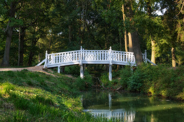A white wooden bridge over a stream
