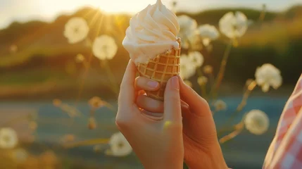 Foto auf Alu-Dibond Woman's hands holding melting ice cream waffle cone in hands on summer light nature background © buraratn