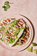 Tacos with grilled chicken, avocado, fresh salsa sauce and limes