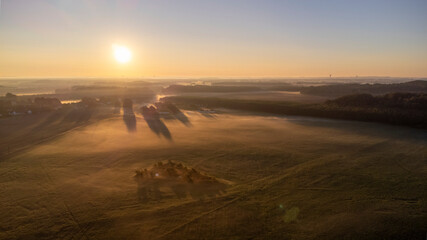Foggy sunrise over wide meadows