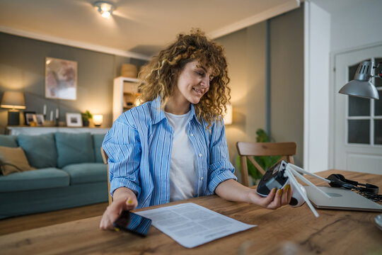 adult caucasian woman adjust prepare home surveillance security camera