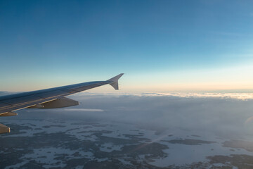 Fototapeta premium Snowy winter landscape in Finnish Lapland view from an airplane window