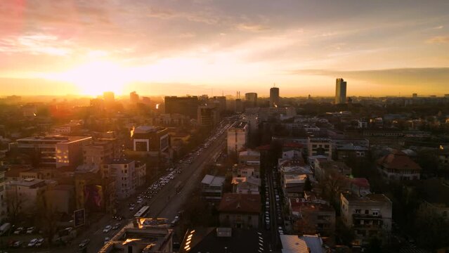 Aerial drone footage of Sector 1 in Bucharest. High angle of traffic and residential buildings at sunset during winter in Romania. Flyover shot of urbaan living. Transportation in the city.
