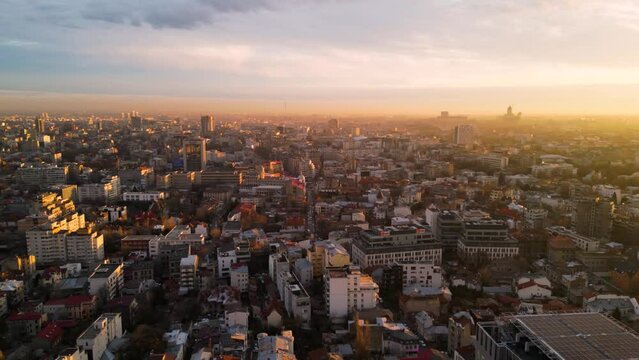 Aerial drone footage of Sector 1 in Bucharest. High angle of traffic and residential buildings at sunset during winter in Romania. Flyover shot of urbaan living. Transportation in the city.
