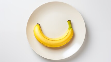 banana, on a white round plate, on a white background, top view