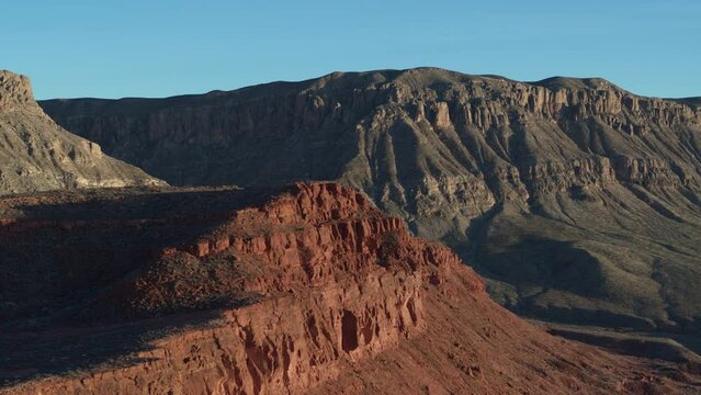 Aerial above red rock cliffs and canyon in St George Utah desert in Warner Valley