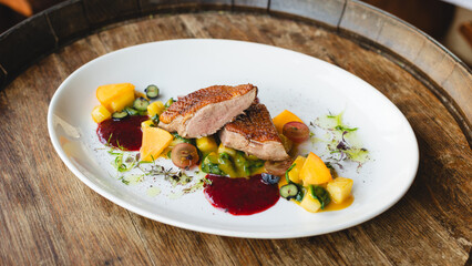 Food photography, delicious duck fillet on a large white plate. Restaurant, banquet, catering.