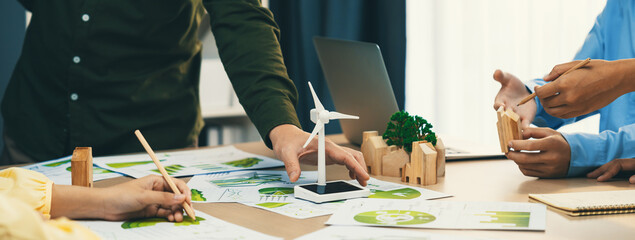 Windmill model represented renewable energy and wooden block represented eco city was placed on...