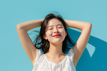 Fototapeta premium Smiling Young Asian Woman Enjoying the Sun with Eyes Closed