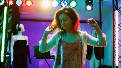 Young person dancing at nightclub, showing cool dance moves in discotheque with funky music....