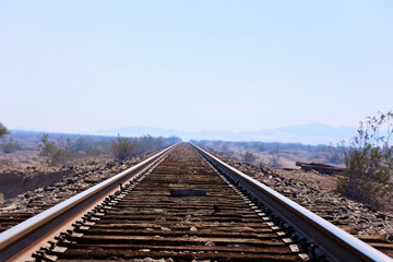 Fototapeta na wymiar desert train tracks disappear into the landscape