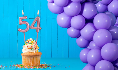 Birthday card with number 54 candle, cupcake and balloons