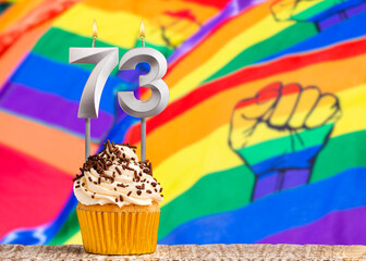 Birthday candle number 73 - Gay march flag background