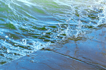 Splash in the water, water droplets, abstract blue background