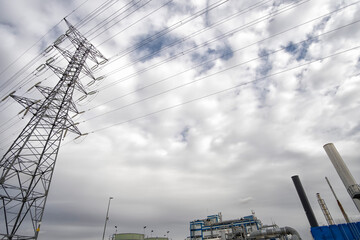 electric grid pylon seen from below, electricity grid pole in a cloudy sky, shot from the...