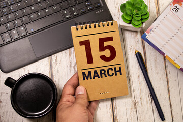 Vintage photo, March 15th. Date of 15 March on wooden cube calendar, copy space for text on board.