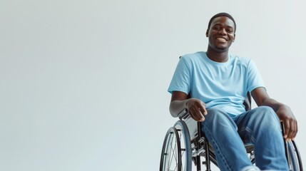 black man with a physical disability smiling and sitting in a wheelchair dressed in jeans, a blue t-shirt, positioned against a white background, Fashion mockup, Lifestyle, Stylish studio background