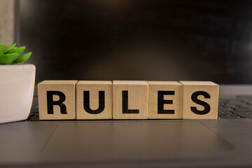 Hand arrange wood letters as Rules word
