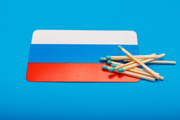 Matches on the background of the Russian flag with selective focus and copy space