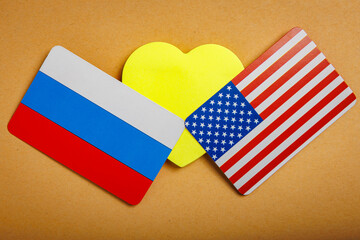 Heart and flag of Russia with the flag of the USA. Background with selective focus and copy space